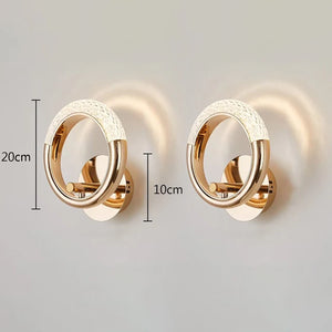 Two Elegant Ring Wall Sconces, finished in a luxurious gold and featuring a sleek circular design. Each crystal ring sconce measures 20 cm in height and 10 cm in width.