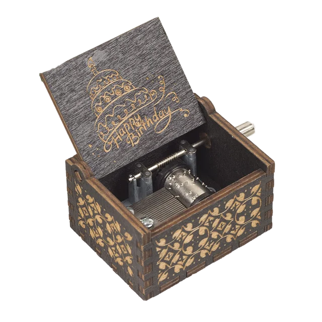 The Happy Birthday Music Box is a wooden music box with ornate carvings and an open lid that features a "Happy Birthday" message and cake illustration, making it the perfect birthday gift. The design exposes the intricate internal music mechanism.