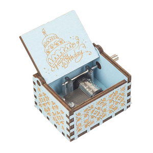 A small, ornate wooden music box with an open lid displaying the engraved text "Happy Birthday" and a cake design on the inside cover. The delightful Happy Birthday Music Box makes for a perfect birthday gift, with its charming musical mechanism nestled inside.