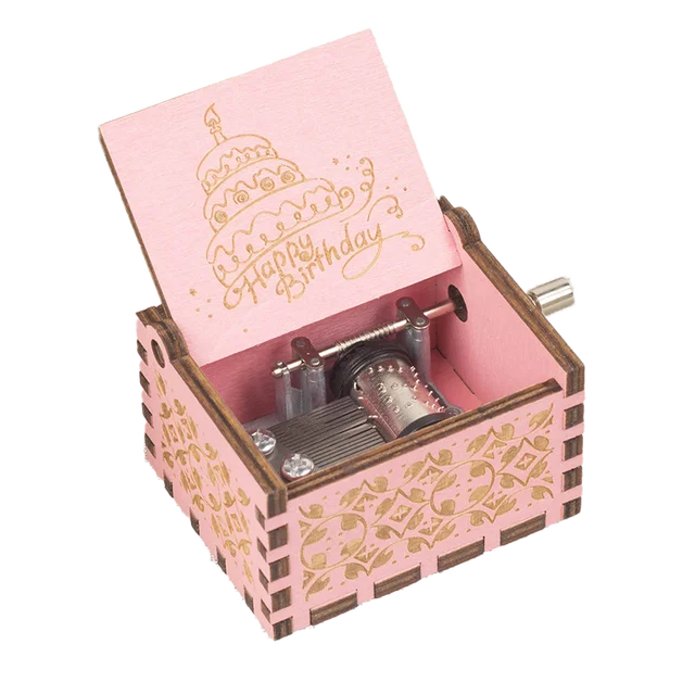 The Happy Birthday Music Box is a small, pink, wooden music box adorned with a "Happy Birthday" message and a charming decorated cake design. Upon opening, it reveals the internal winding mechanism. This delightful hand-cranked music box brings a nostalgic touch to any celebration.