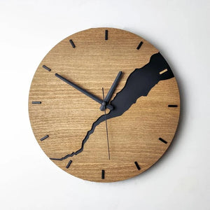 Introducing the Wooden Round Wall Clock, a striking focal piece that combines rustic and modern elements. It features a natural wood finish adorned with an irregular black pattern. The clock's distinctive black hour and minute hands align at 10:10, while the second hand is just past 12, making it an eye-catching addition to any room.