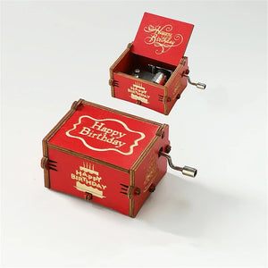 Happy Birthday Music Box: Red hand-crank wooden music box featuring "Happy Birthday" text. Displayed in both open and closed positions, this charming music box reveals its intricate internal components when opened, making it a delightful birthday gift for any celebration.