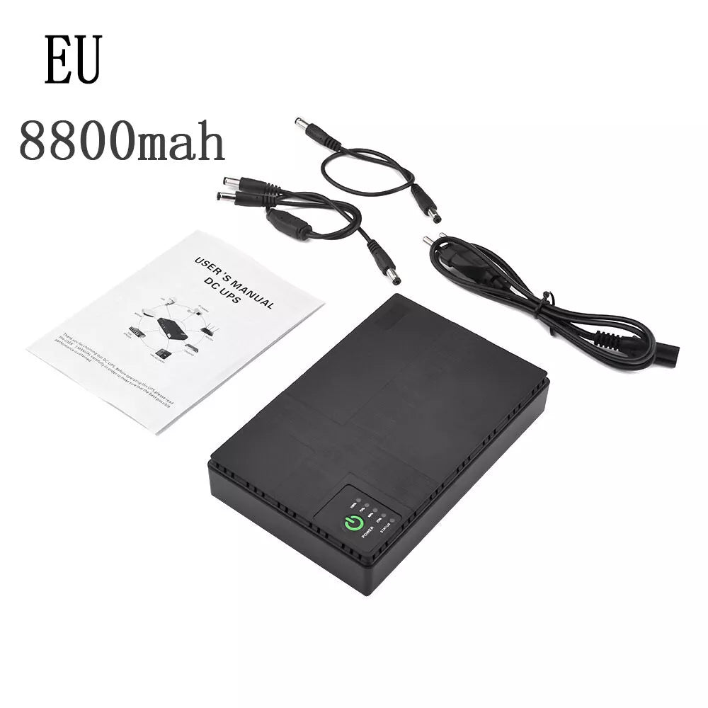 A black Portable UPS for WiFi Router with an 8800mAh battery, user manual, and various charging cables are laid out on a white surface. Text reads "EU 8800mah". Ideal for use as a WiFi Router Backup.