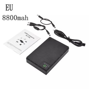 A black Portable UPS for WiFi Router with an 8800mAh battery, user manual, and various charging cables are laid out on a white surface. Text reads "EU 8800mah". Ideal for use as a WiFi Router Backup.