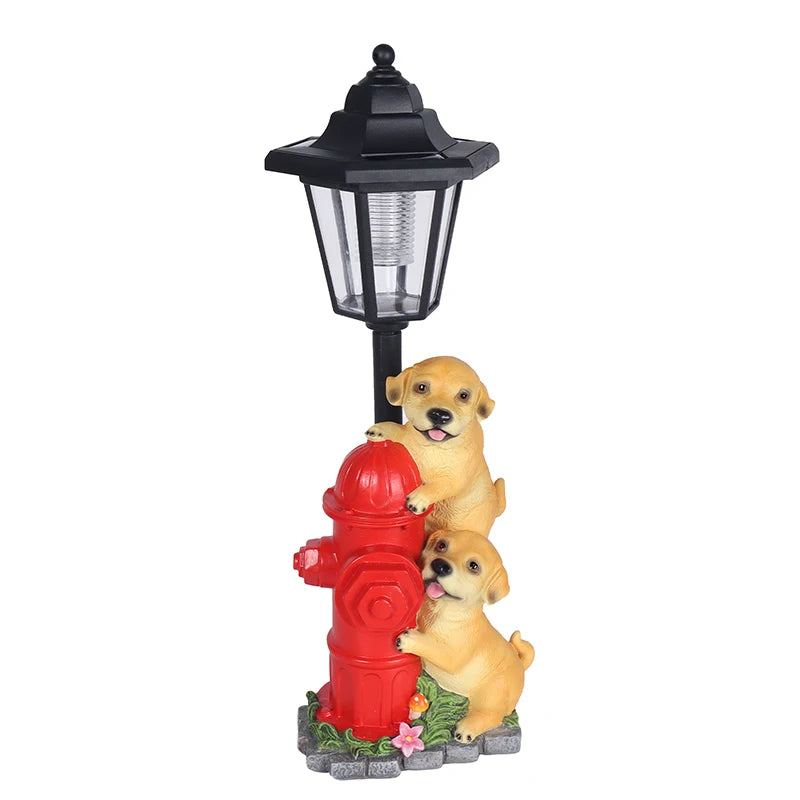 Two yellow Solar Dog Light puppies playfully lean on a red fire hydrant beneath a vintage street lamp, with a small flower and grass at the base.