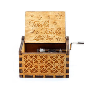 The Wooden Music Box is a handmade wooden creation featuring a carved design and an open lid that proudly displays "Twinkle Twinkle Little Star." This hand-cranked wooden music box plays timeless tunes, infusing any space with a touch of nostalgia.