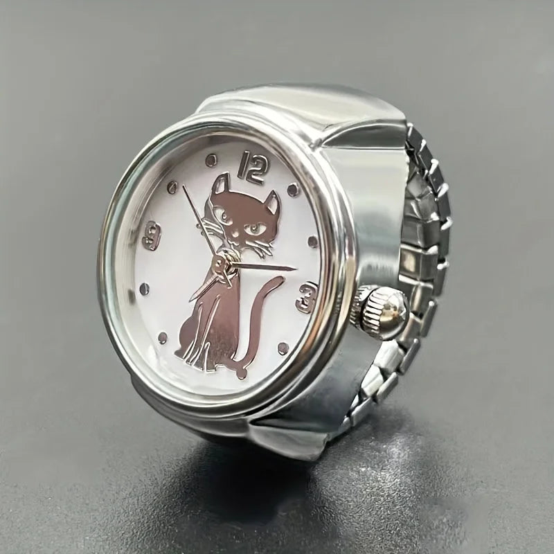 The Cat Ring Watch is a silver wristwatch with a white face featuring a stylized cat; its front paws serve as the hour and minute hands.