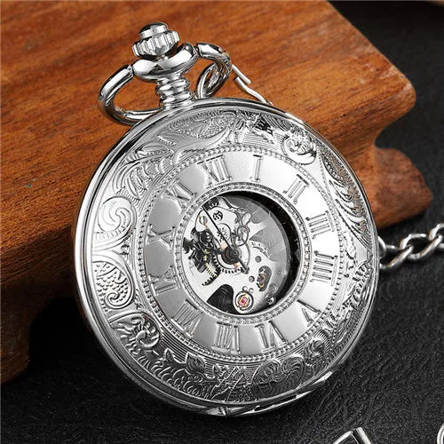 The Vintage Mechanical Pocket Watch displays Roman numerals and elegant engravings, with part of its internal mechanism visible through a small glass window.