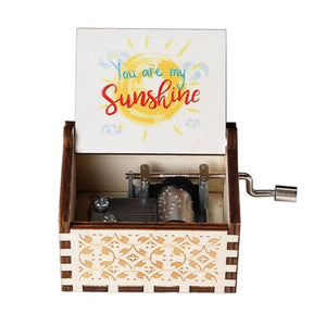 A "Music Box - You Are My Sunshine" features a hand-crank mechanism and intricate carvings, opening to reveal its inner workings. The lid showcases a sun graphic along with the text "You Are My Sunshine," playing the classic melody through its romantic rotary handle.