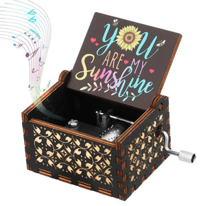 A romantic rotary handle music box, named "Music Box - You Are My Sunshine," meticulously crafted from fine wood, featuring an open lid that displays the words "You Are My Sunshine" while musical notes gracefully emanate from it.