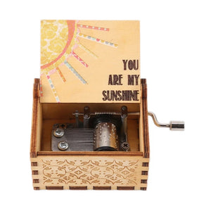 The Music Box - You Are My Sunshine has a lid that opens to showcase the detailed inner workings. Inside the lid, it features a stunning design with a sun and the touching message, "You Are My Sunshine," making it one of the most enchanting wooden music boxes for your loved one.