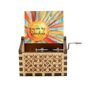 The "Music Box - You Are My Sunshine" features intricate carvings and displays a colorful card with a sun illustration and the words "You Are My Sunshine." The hand-cranked rotary handle mechanism adds a charming touch to this exquisite piece, making it a perfect gift for your loved one.