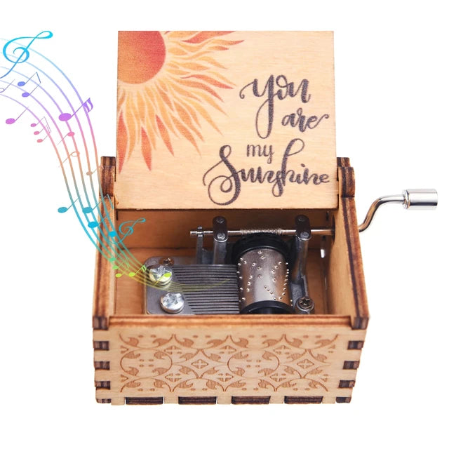 The "Music Box - You Are My Sunshine" features a romantic rotary handle design with a classic melody. This wooden hand-crank music box has a lid adorned with a sun illustration and the heartfelt text "You Are My Sunshine," complemented by colorful musical notes emanating from it.