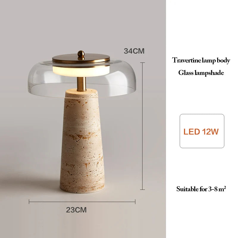 The Mushroom Desk Lamp features a natural travertine stone base, a glass lampshade, and elegant brass accents. Measuring 34 cm in height and 23 cm in width, this modern lamp includes an energy-efficient 12W LED light and is ideal for illuminating spaces of 3-8 m².