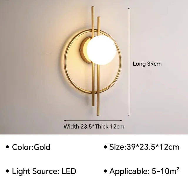 The Circular Wall Sconce with Dual Vertical Rods, a gold-colored LED wall lamp with dimensions of 39 x 23.5 x 12 cm, is shown. It is suitable for spaces of 5-10 m².