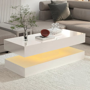 The Premium Coffee Table, a modern white design with a floating top and ambient yellow LED lighting, is placed in front of a beige sectional sofa and displays decorative items on its surface.