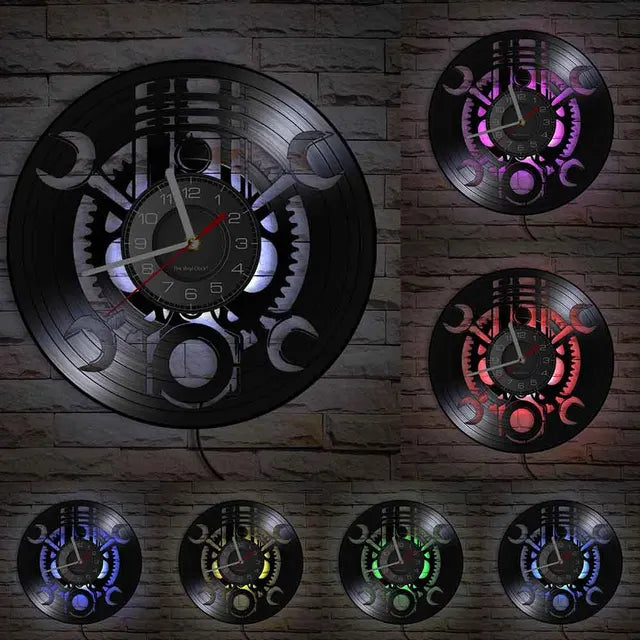 The Black Record Wall Clock features wrench cut-outs with gears, set against a brick backdrop and illuminated in various backlight colors.