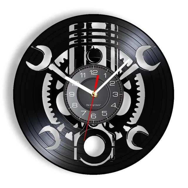 The Black Record Wall Clock is crafted from a black vinyl record featuring silver wrench cut-outs and gear patterns, and is highlighted by a striking red second hand. This rustic industrial wall clock adds unique charm to any space.