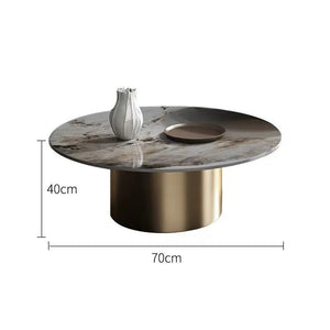 The Premium Round Coffee Table features a marble-look sintered stone top, gold cylindrical base, and includes a chic white vase and dish. Measuring 40cm high by 70cm wide, it brings modern elegance to any space.