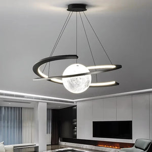 The Moon Trajectory Pendant Light, an orbital chandelier with LED technology, spherical lights, and metal rings, graces a modern living room ceiling for a celestial effect.