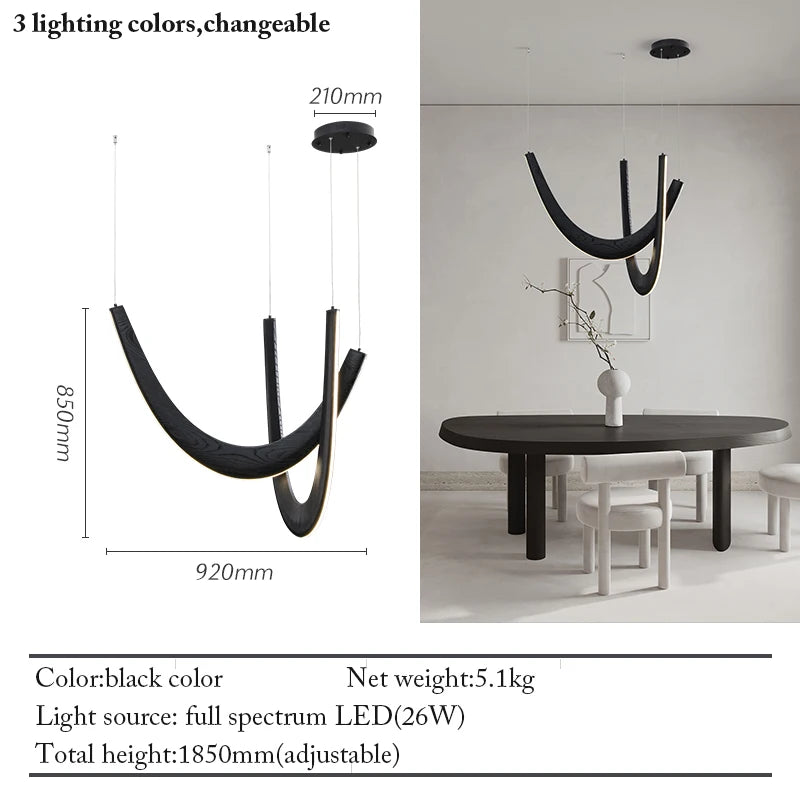The Double Curve Wood Pendant Light in black with a modern curved design hangs above an oval dining table; dimensions and specs are shown on the left side of the image.