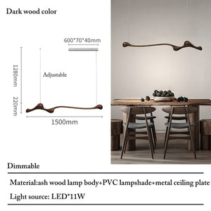 The Tideform Biomorphic Pendant Light, featuring an irregular ash wood body, is a sculptural LED fixture suspended above a dining table for four—perfect for showcasing Nordic minimalism with its unique lamp size and material.