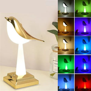 The Bird Table Night Light, renowned for its elegant craftsmanship, stands on a golden stand and features adjustable lighting. On the right, nine smaller images showcase its contemporary design as it emits various colors: white, yellow, blue, red, green, and purple.