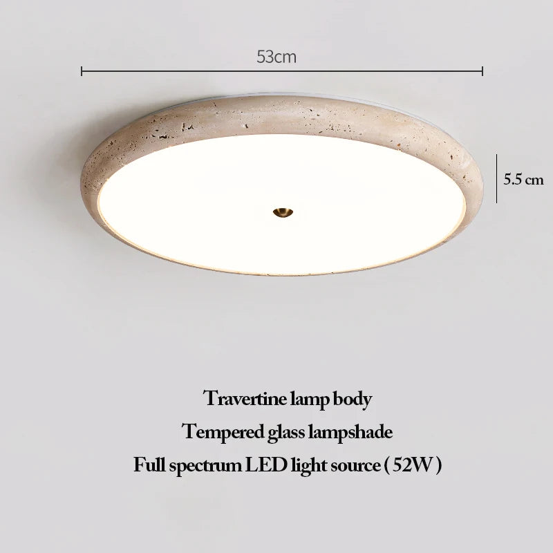 The Natural Stone Ceiling Light features a round travertine body, a tempered glass lampshade, and a full spectrum 52W LED. Inspired by wabi-sabi lighting principles, this fixture measures 53 cm in diameter and 5.5 cm in height.