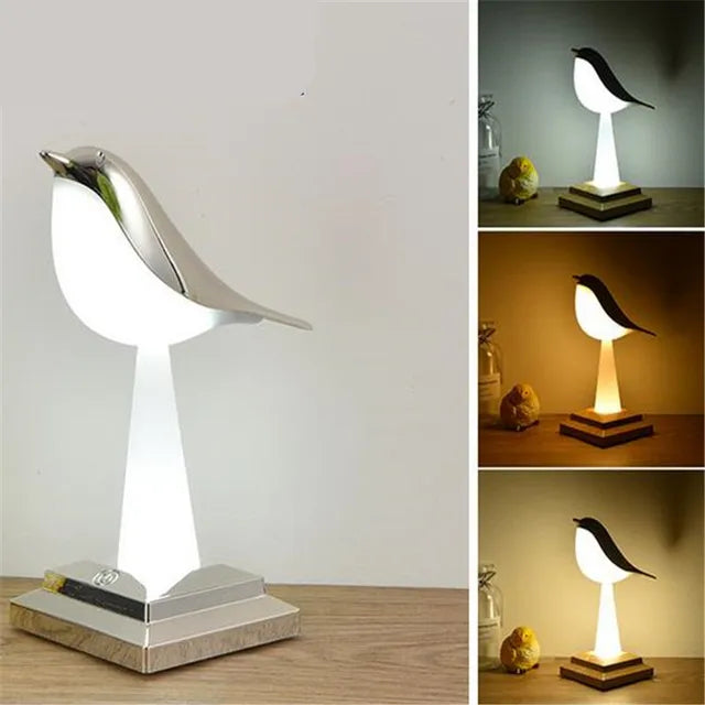 The Bird Table Night Light features a glowing white light on a wooden base. The image highlights its minimalist design and three lighting settings: white, yellow, and dim yellow.
