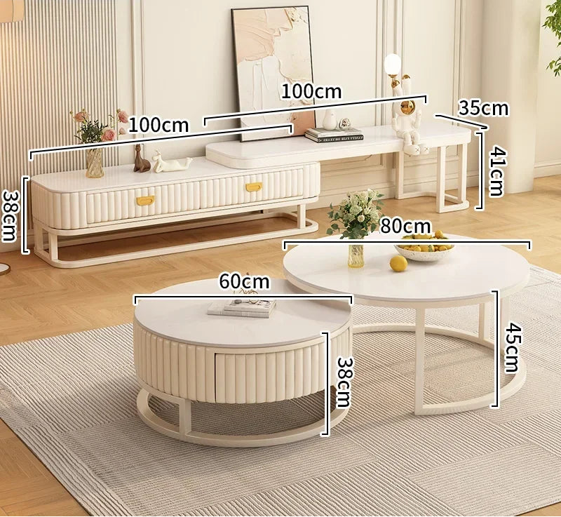 A modern living room featuring the Luxury Round Coffee Table Set, with white, marble-look tables in various sizes, each displaying width and height measurements in centimeters.