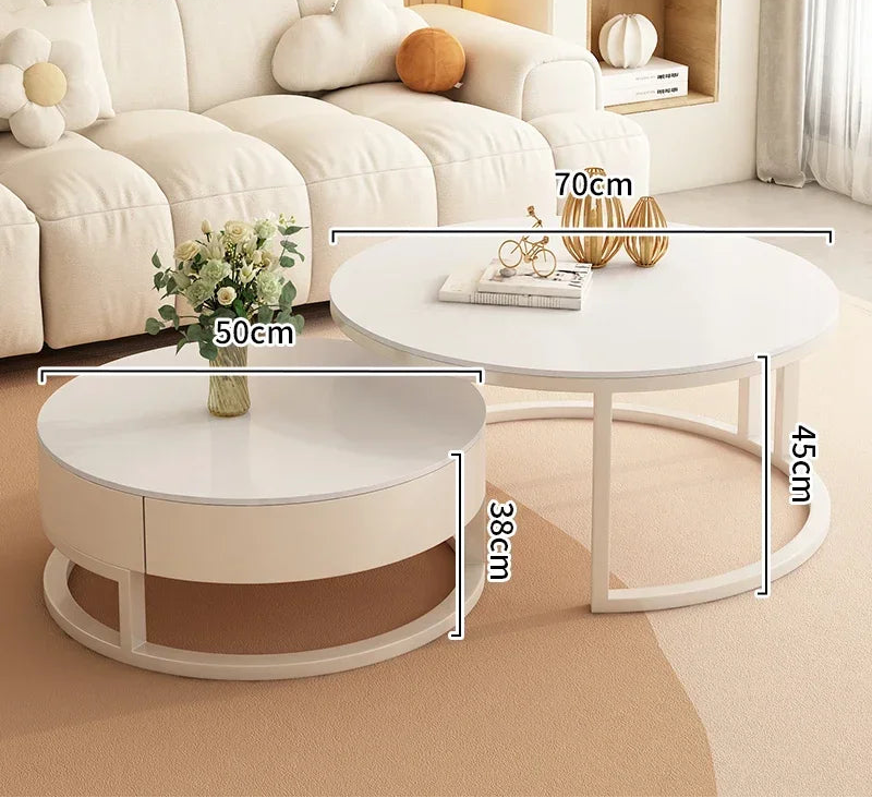 The Luxury Round Coffee Table Set features two white minimalist tables: one with a marble-look top measuring 70cm wide and 45cm tall, and the other 50cm wide and 38cm tall.