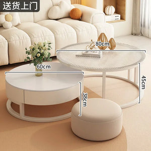 The Luxury Round Coffee Table Set, featuring two minimalist round tables (80x45cm and 60x38cm) and a round ottoman, is placed in front of a cream sofa.