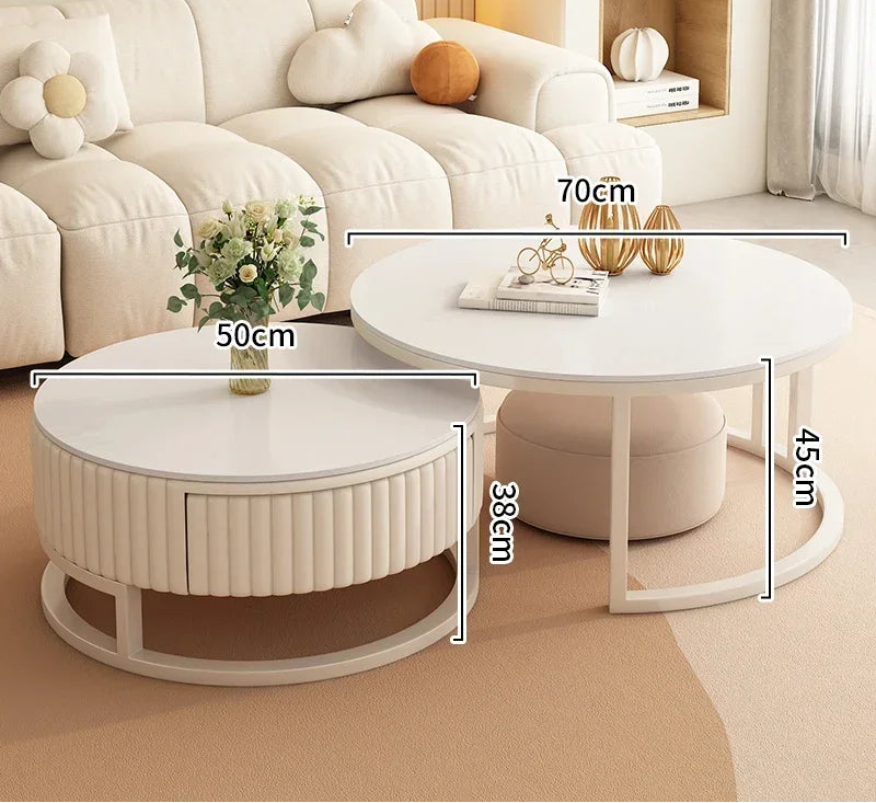 The Luxury Round Coffee Table Set, featuring two white round tables of varying heights and diameters, is displayed in a living room with minimalist design and labeled width and height measurements in centimeters.