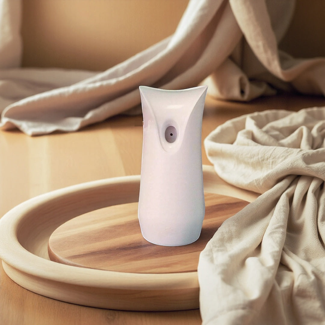 A white air freshener on a wooden tray amidst fabric is actually a White Decorative Display SpyCam with advanced surveillance features.