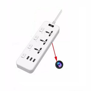 The Power Strip SpyCam, a white power strip featuring multiple sockets and USB ports, is depicted. A red arrow highlights a small, round object resembling a camera lens attached to the power strip, uncovering its covert surveillance capability with 1080P HD video quality.