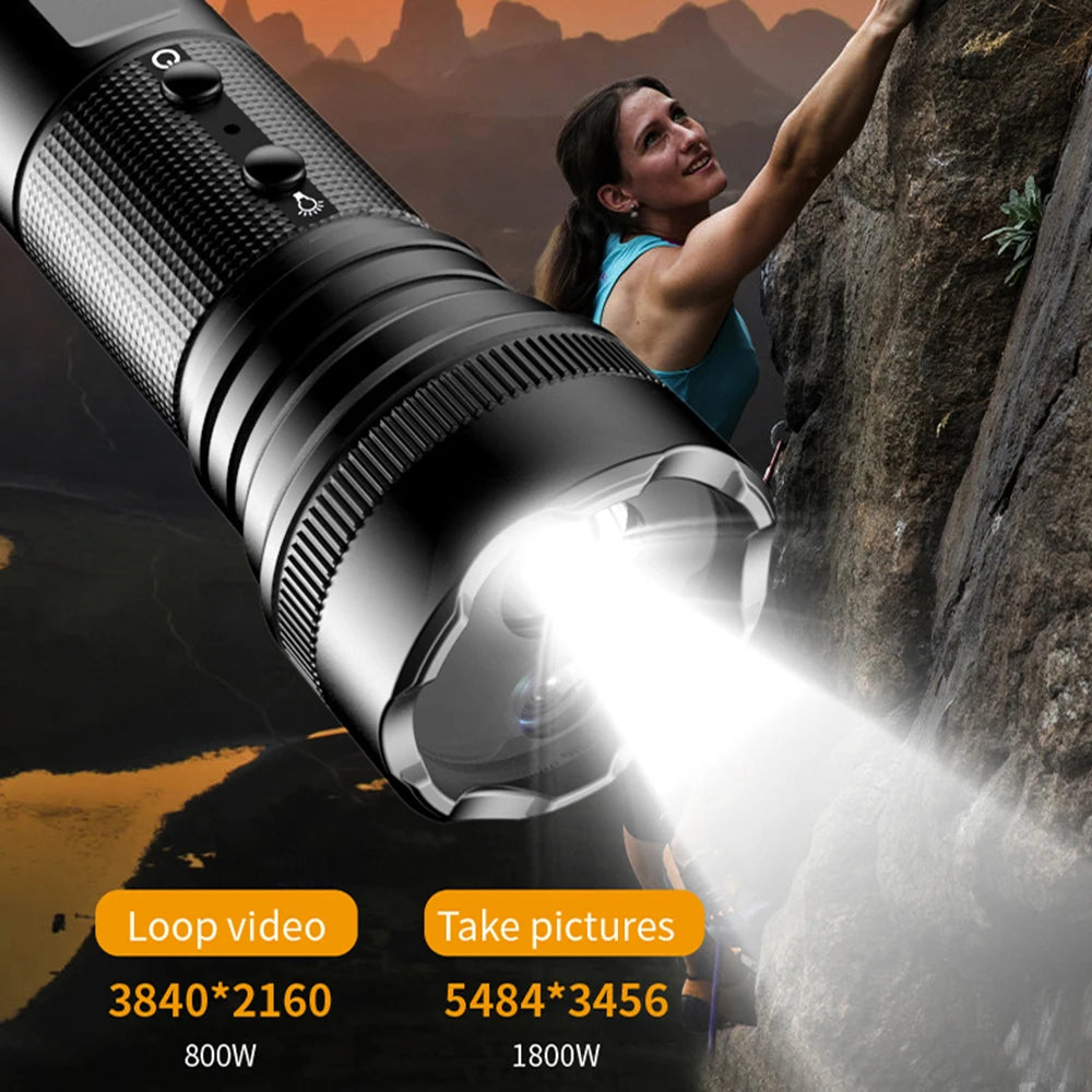 A woman climbs a rocky surface with the Outdoor Flashlight SpyCam in the foreground, showing 1080p video and photo resolution options. Its waterproof design makes it perfect for rugged outdoor adventures.