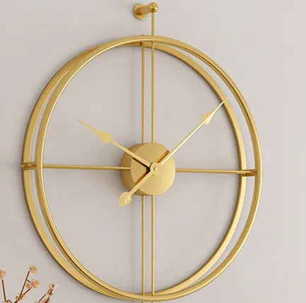 A modern gold Minimalist Ring Wall Clock with a simple design displayed on a light-colored wall.