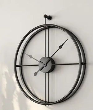 A modern minimalist black ring wall clock with a simple design, showing approximately 10:10.