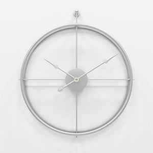 Minimalist Ring Wall Clock with a silver frame on a white wall, embodying simplicity and minimalism.