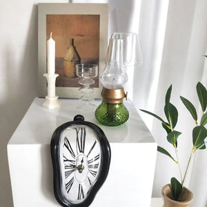 A clock with a Unique Funny Twist on a white table, reminiscent of Salvador Dali's artistic flair.