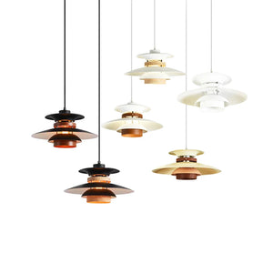 A group of scandinavian pendant lights made of natural wood hanging from a white background.
