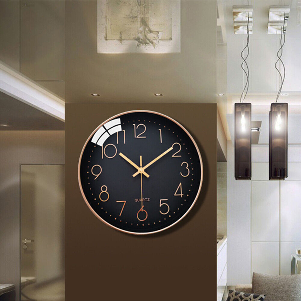 A large, modern living space featuring a HD 1080P Wall Clock SpyCam with motion detection includes a wall clock with a black face and gold numerals hanging on a brown wall. The elegant setup is complemented by two pendant lights and abstract artwork, seamlessly integrating added security into the décor.