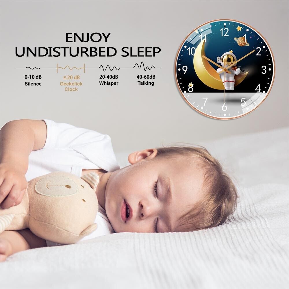 A toddler sleeps next to the Astronaut Moon Clock SpyCam, its cartoon design gently keeping time. Above, "Enjoy Undisturbed Sleep" is written alongside a noise level chart.