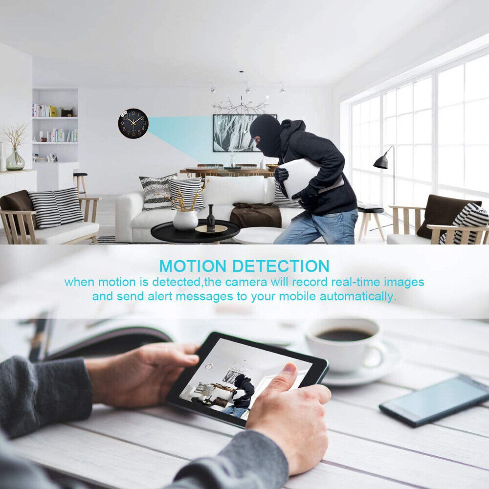 A person dressed in dark clothing and a balaclava is moving inside a modern living room, likely triggering the Motion Detection feature on the Wall Clock SpyCam. A tablet displays an HD 1080P real-time image of the intruder captured by the camera.