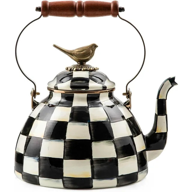 A decorative kettle in black and white checkered design with a bird on the lid top.