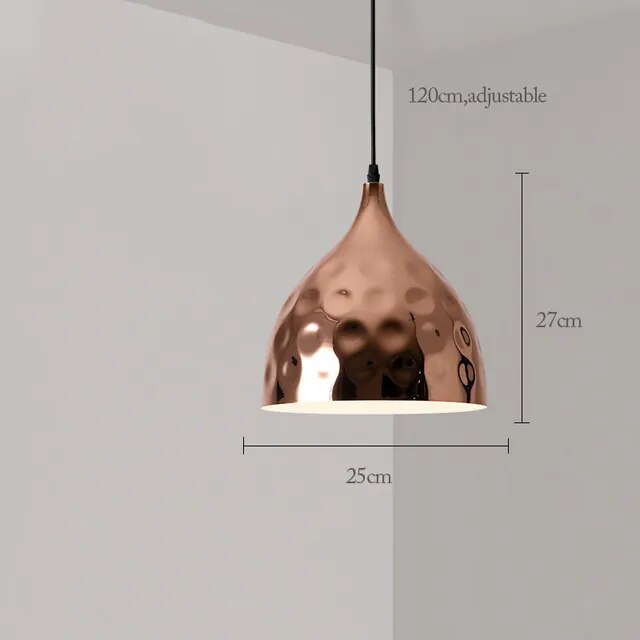 The Nordic Rose Gold Pendant Light combines modern design with a hammered texture. It measures 27cm in height and 25cm in diameter, and the adjustable cord extends up to 120cm, offering both style and functionality.