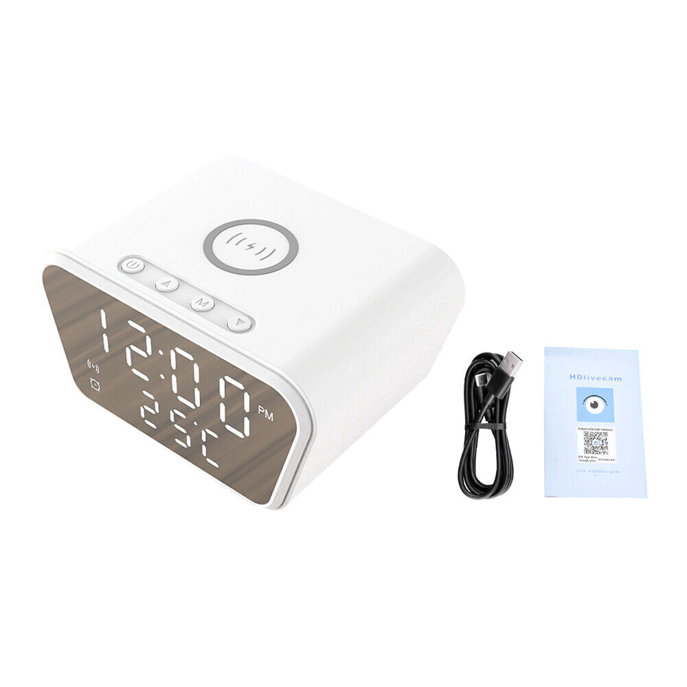The sleek Clock Charger SpyCam is a white digital alarm clock showing 12:00 PM and 25°C. It features top buttons for easy control, discreetly integrates a hidden camera with clear 1080P video recording, and includes a USB cable and manual for setup.