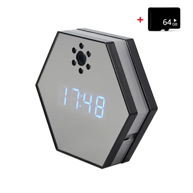 The Sleek Clock SpyCam is a hexagonal digital clock with a blue LED display showing 17:48, a discreet spy camera lens above the screen, infrared night vision, and comes with a 64GB microSD card displayed in the top right corner.